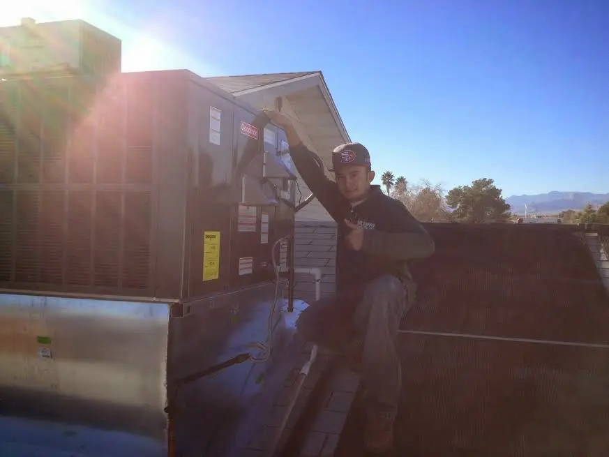 HVAC technician performing AC Tune-Up on a rooftop unit in Birdsboro